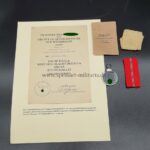 Ostmedaille mit Verleihungstüte und Urkunde, Hst. 18 - "Karl Wurster KG, Markneukirchen", Winterschlacht im Osten 1941/42