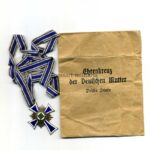 Ehrenkreuz der deutschen Mutter in Bronze (Mutterkreuz) mit Verleihungstüte, „Gebrüder Lange, Lüdenscheid“
