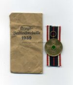 Kriegsverdienstmedaille 1939 mit Tüte, Hst. F. W. Assmann & Söhne, Lüdenscheid